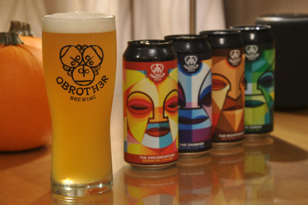 O'Brother brewing can collection alongside glass glass
